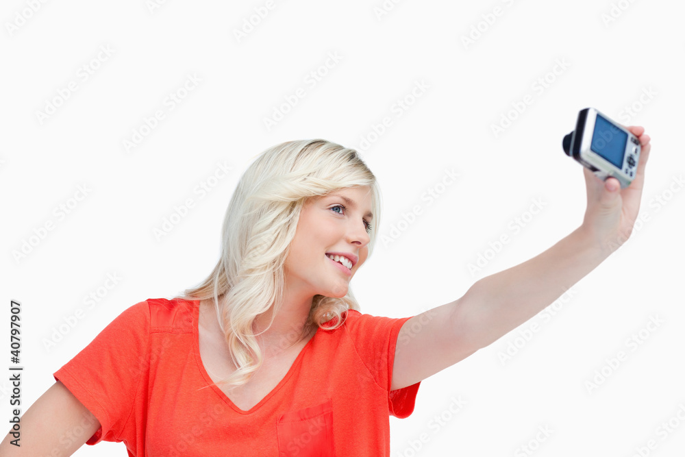 Smiling teenager photographing herself Smiling teenager photographing herself