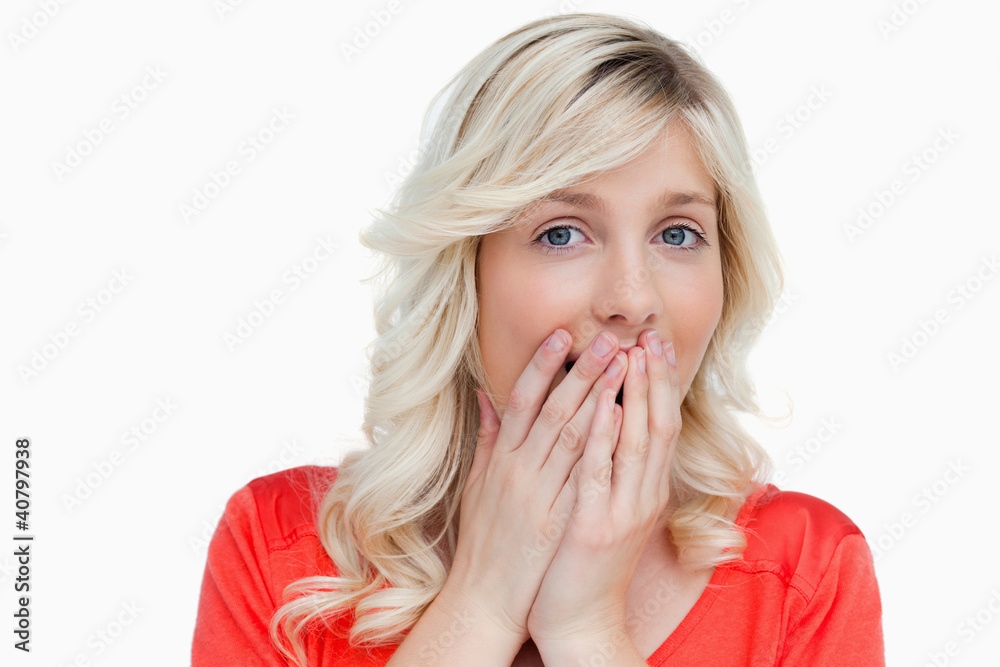Surprised attractive woman placing her hands on her mouth Surprised attractive woman placing her hands on her mouth