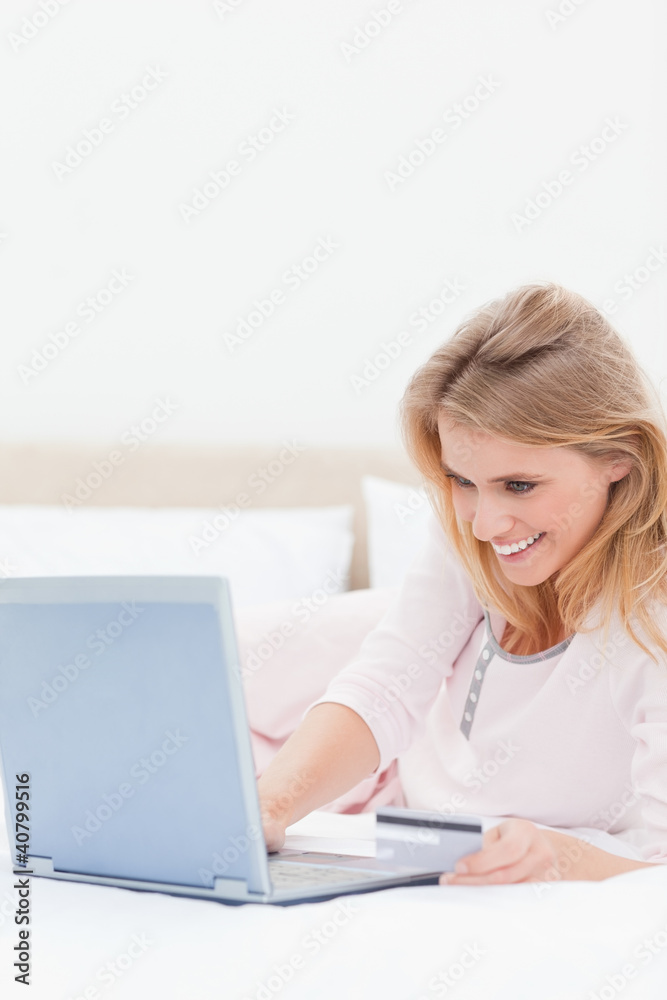 Close up, Woman using laptop on the bed while looking at the scr Close up, Woman using laptop on the bed while looking at the scr