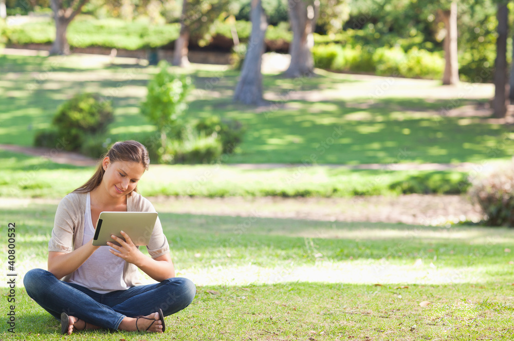 Woman in the park with a tablet computer Woman in the park with a tablet computer