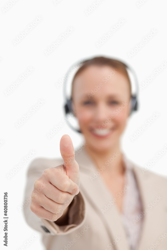 Thumbs up of a businesswoman wearing a headset Thumbs up of a businesswoman wearing a headset
