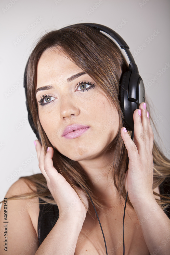 Beautiful cheerful young woman enjoying music Beautiful cheerful young woman enjoying music