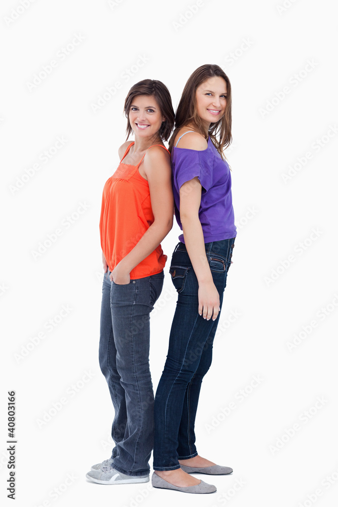 Teenagers standing back to back Teenagers standing back to back