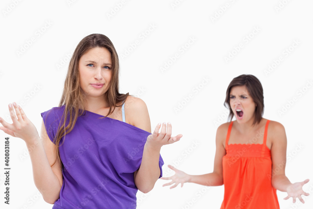 Teenage girl ignorant to her exasperated friend Teenage girl ignorant to her exasperated friend