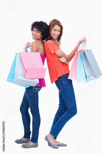 Two teenage girls holding shopping bags © WavebreakmediaMicro