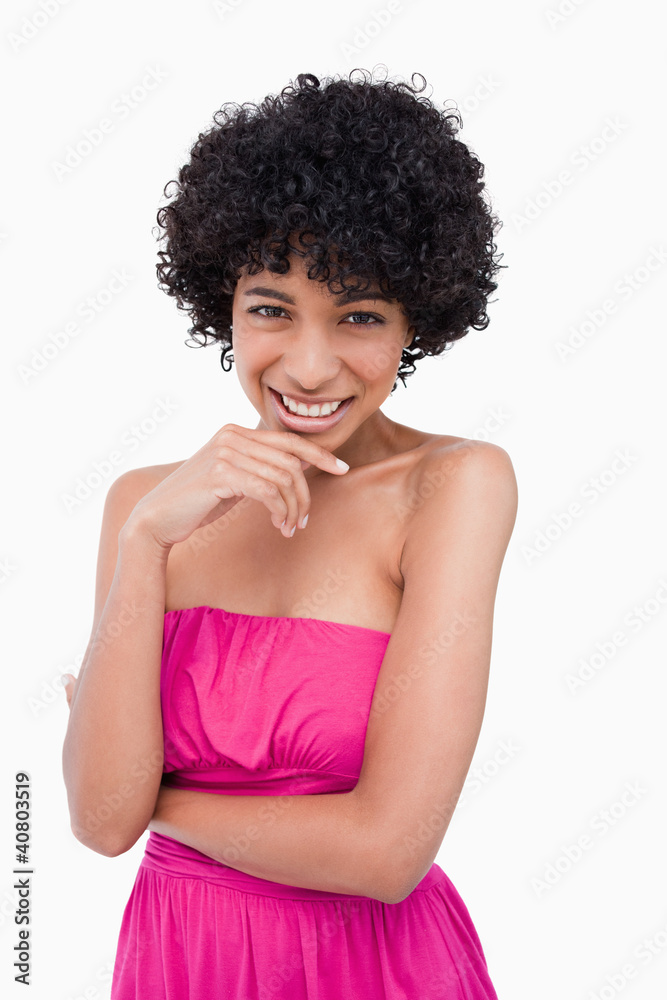 Young smiling woman standing with her arms crossed and her hand Young smiling woman standing with her arms crossed and her hand