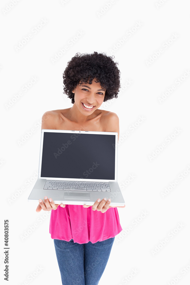 Smiling and beautiful teenager holding her laptop Smiling and beautiful teenager holding her laptop