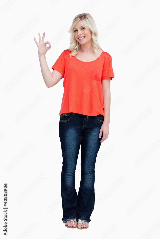Smiling teenager looking at the camera while showing the OK sign Smiling teenager looking at the camera while showing the OK sign