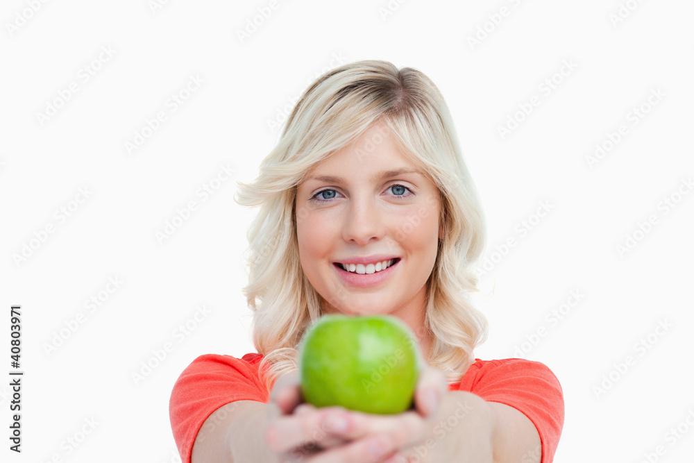Smiling woman holding a delicious green apple Smiling woman holding a delicious green apple