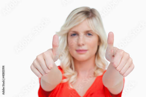 Two thumbs up being showed by a young attractive woman