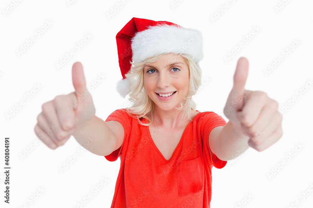 Smiling young woman putting her thumbs up in satisfaction Smiling young woman putting her thumbs up in satisfaction