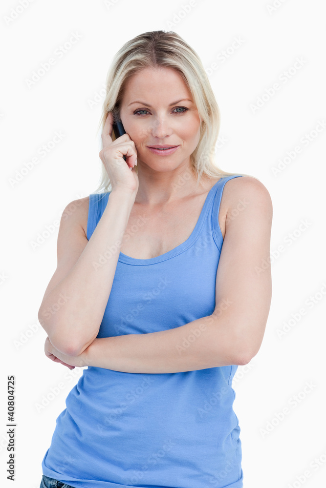 Blonde woman crossing her arms while calling Blonde woman crossing her arms while calling