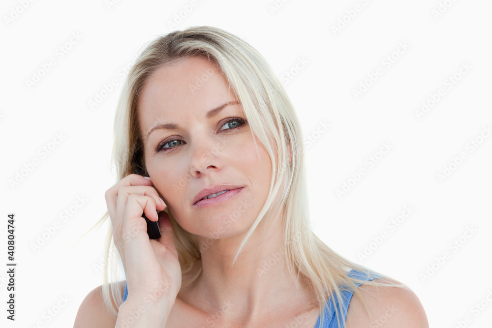 Blonde woman looking to the side while calling Blonde woman looking to the side while calling