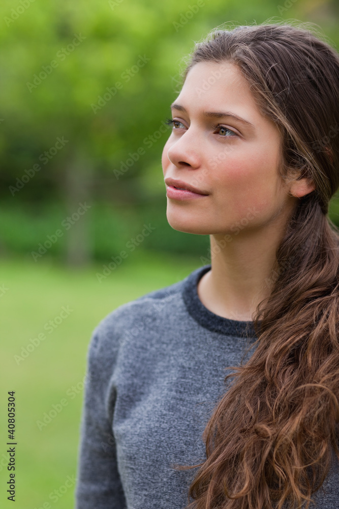 Thoughtful young girl looking towards the side