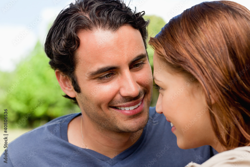 Fototapeta premium Two friends laughing while they are both sitting together on the