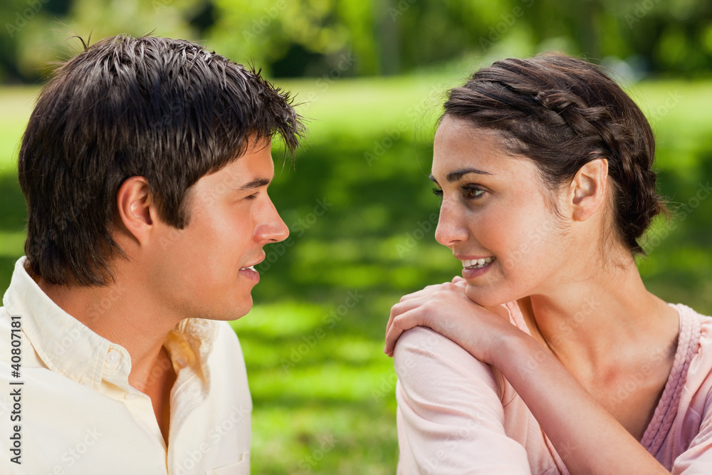 Woman looking at her friend while holding her shoulder Woman looking at her friend while holding her shoulder