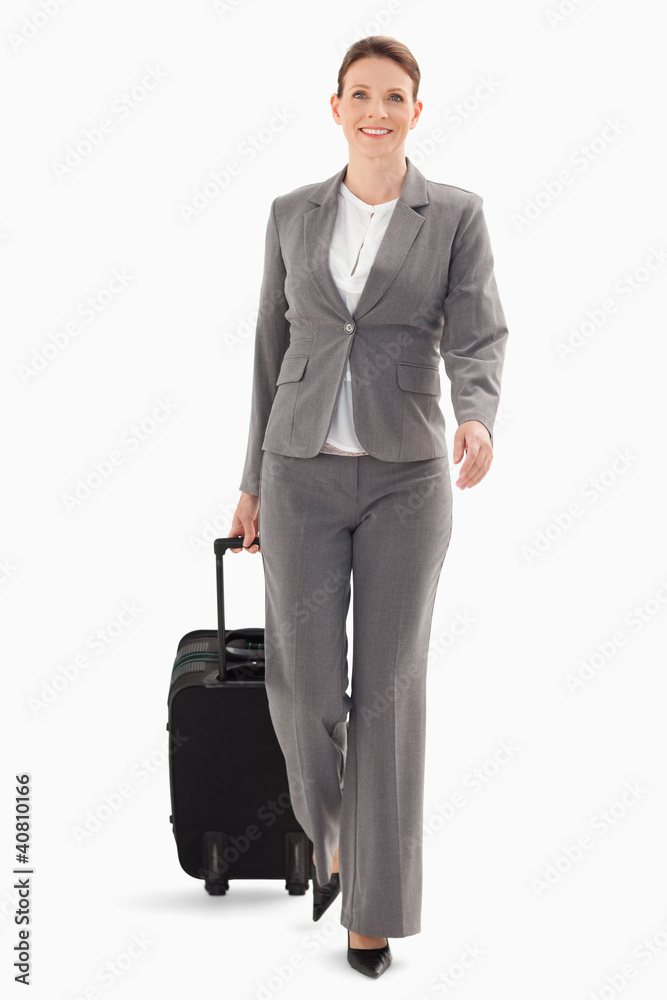 Businesswoman walking forward with a suitcase Businesswoman walking forward with a suitcase