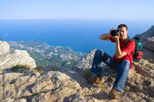 Photographer with digital camera on mountain