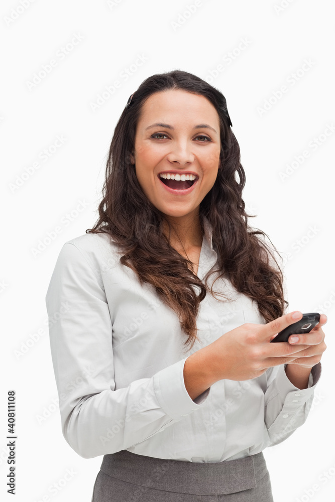 Portrait of a happy brunette looking her text message Portrait of a happy brunette looking her text message