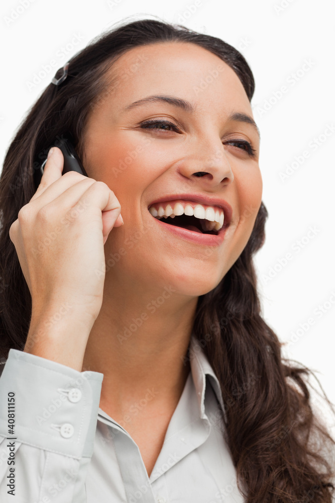 Close-up of a brunette beaming while calling Close-up of a brunette beaming while calling