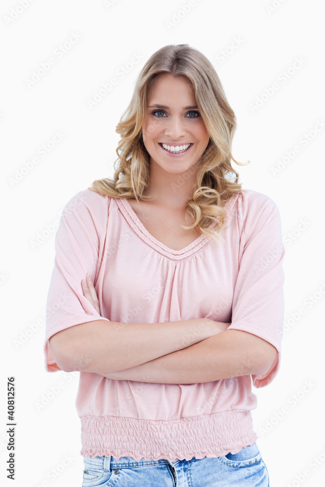 A smiling woman standing with her arms folded A smiling woman standing with her arms folded
