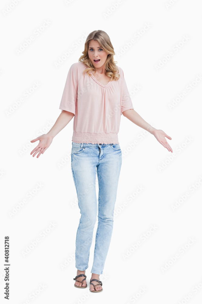 Young woman raising her hands while being surprised Young woman raising her hands while being surprised