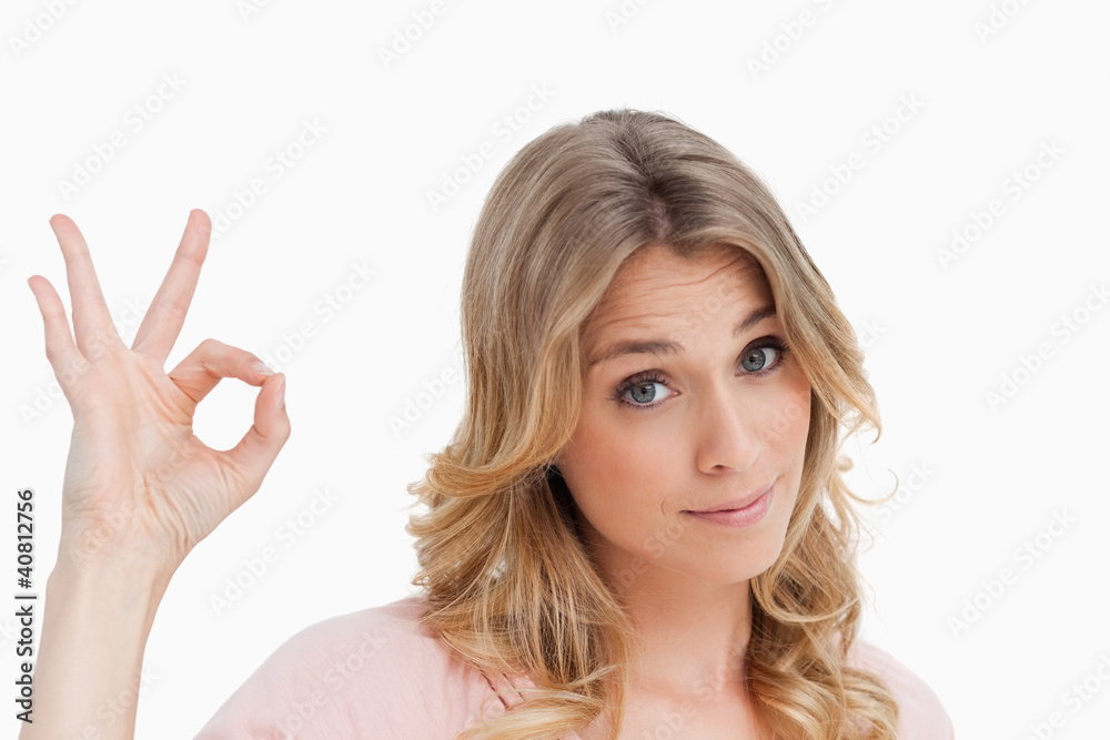 Relaxed young woman showing the ok sign Relaxed young woman showing the ok sign