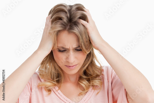 Angry young woman placing her hands on her head