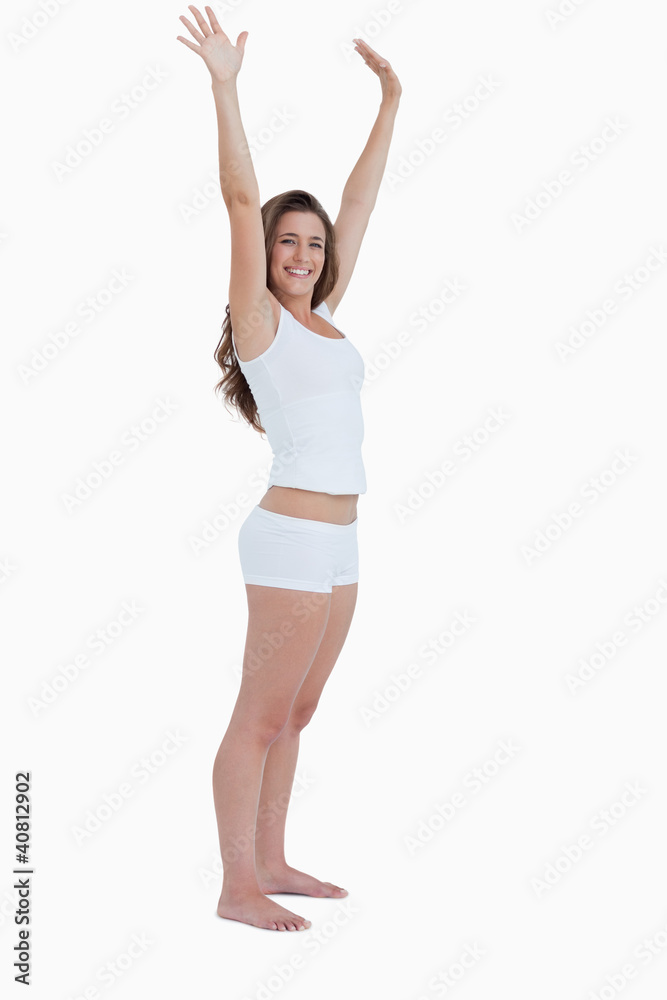 Smiling woman raising her arms above her head Smiling woman raising her arms above her head