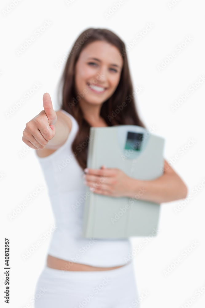Thumbs up being placed by a brunette woman Thumbs up being placed by a brunette woman