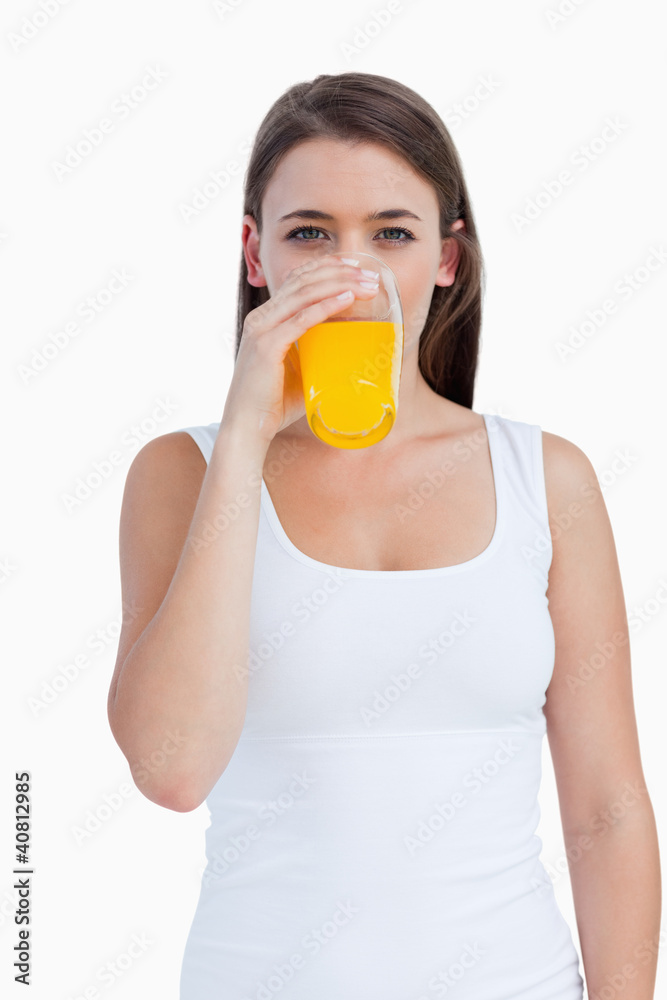 Young woman drinking an orange juice