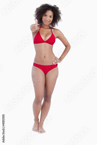 Smiling woman placing her thumbs up