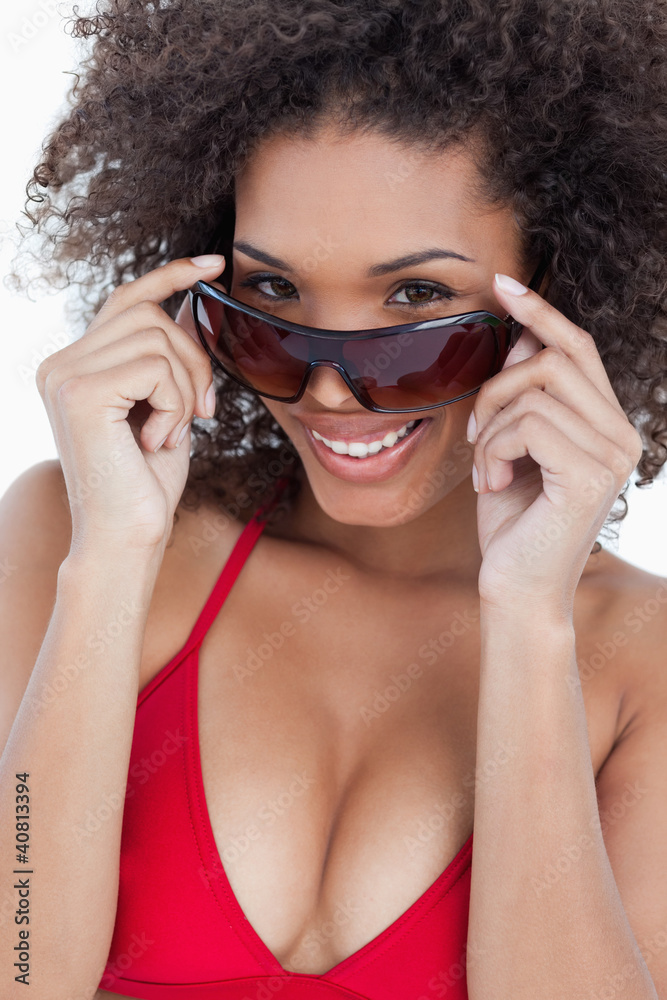 Attractive brunette holding her sunglasses while smiling Attractive brunette holding her sunglasses while smiling
