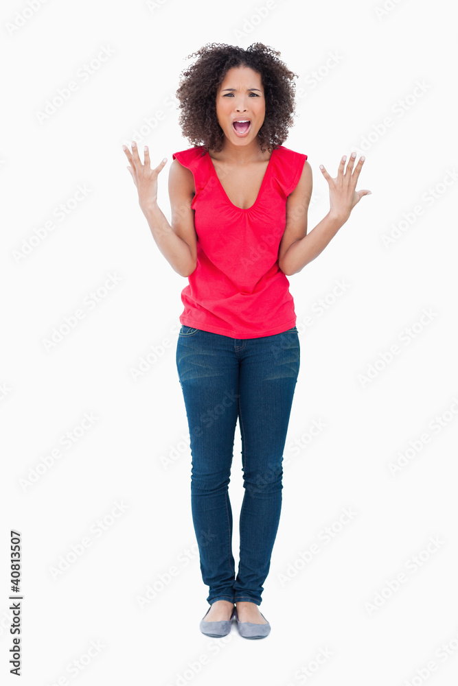 Upset brunette woman raising her arms Upset brunette woman raising her arms