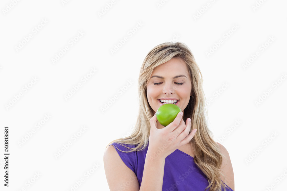 Smiling woman holding a delicious apple Smiling woman holding a delicious apple