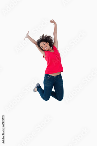 Happy young woman jumping in the air