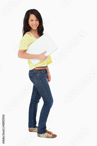 Beautiful Latin student holding a laptop