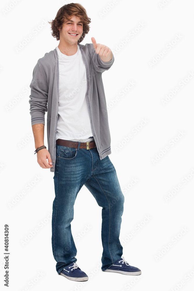 Smiling male student posing the thumb-up Smiling male student posing the thumb-up