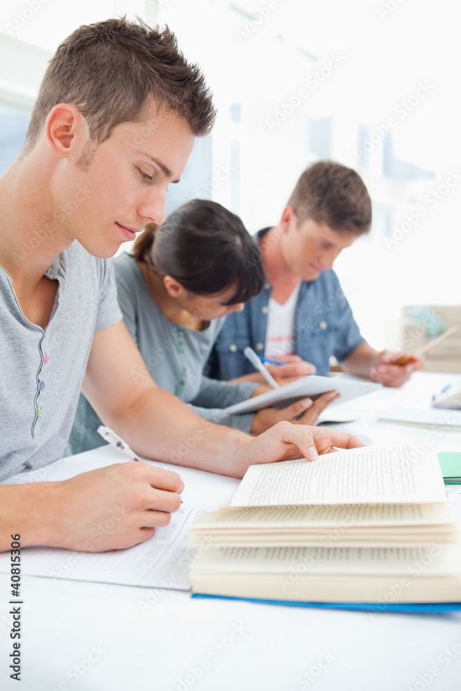 Close up of three students studying hard Close up of three students studying hard