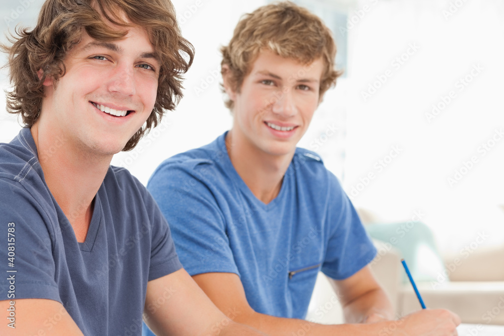 Two male students looking into the camera and smiling Two male students looking into the camera and smiling