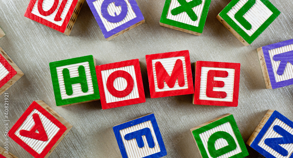 Wooden blocks forming the word HOME in the center Wooden blocks forming the word HOME in the center