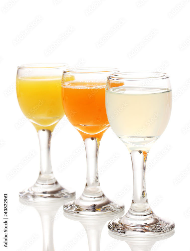 Tropical juices in glasses isolated on white Tropical juices in glasses isolated on white