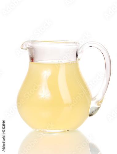 Tropical juice in glass pitcher isolated on white