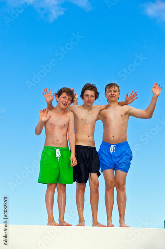 three friends in swimmware stick together