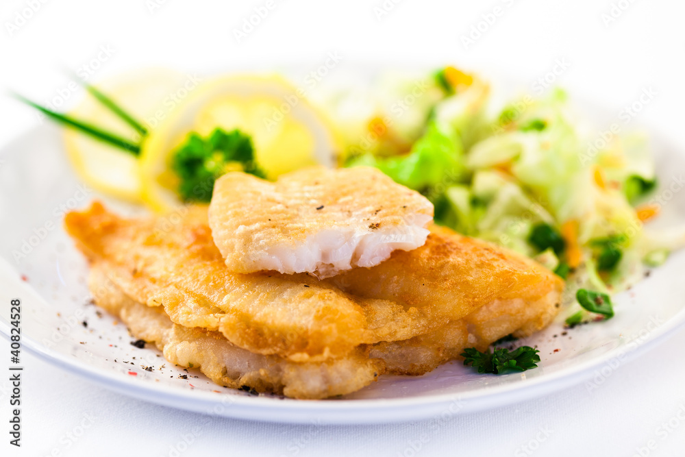 Fish dish - fried fish fillets and vegetable salad