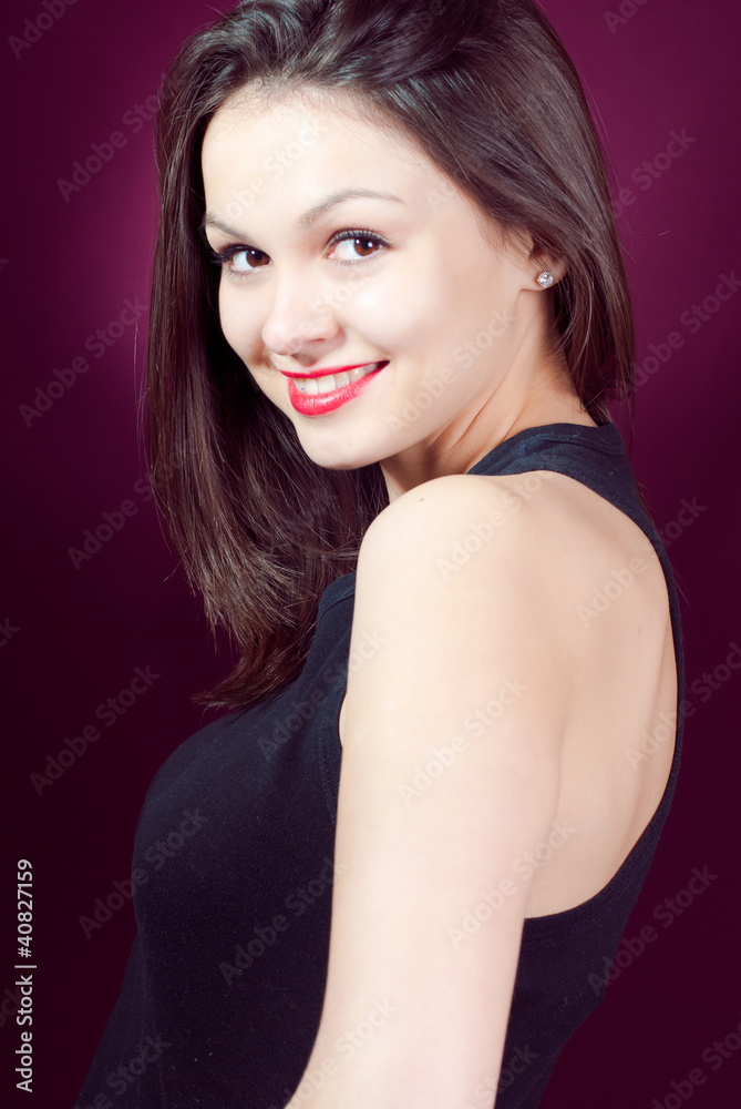 Fototapeta premium Young beautiful woman on maroon background