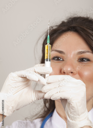 Close up of a beautiful woman doctor hold an injection
