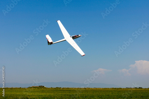 Glider flying on a blue sky