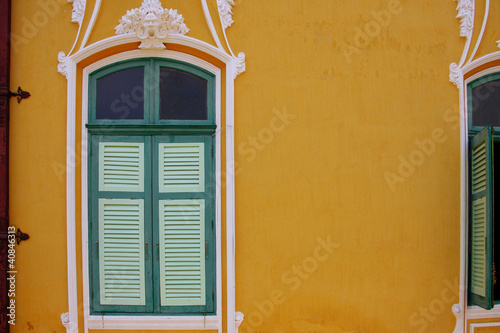 wooden window on yellow wall