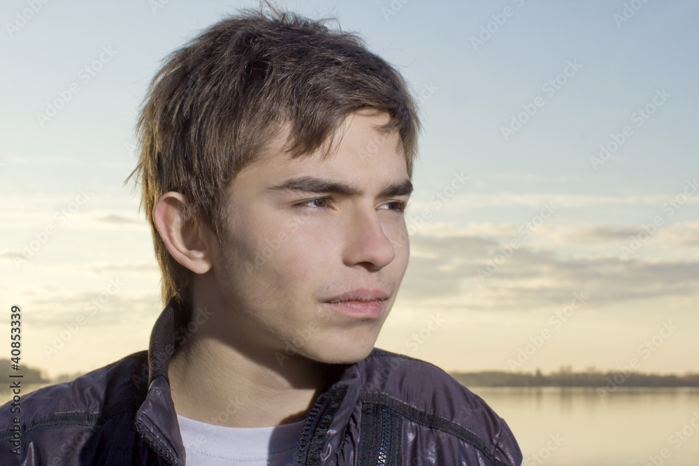 Portrait of the thoughtful young man against the evening sky Portrait of the thoughtful young man against the evening sky